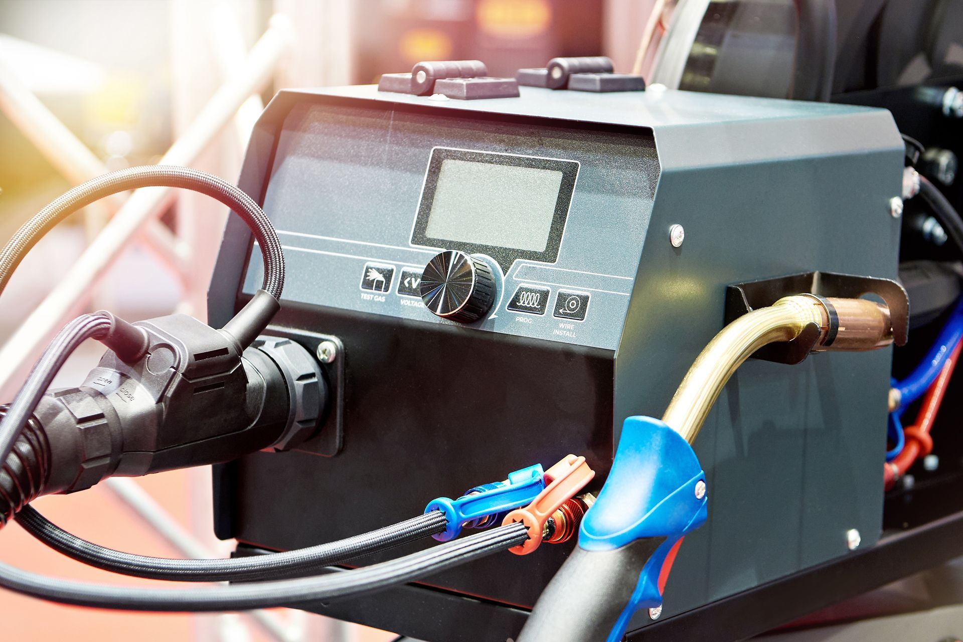 Welding machine with digital display and various cables and attachments