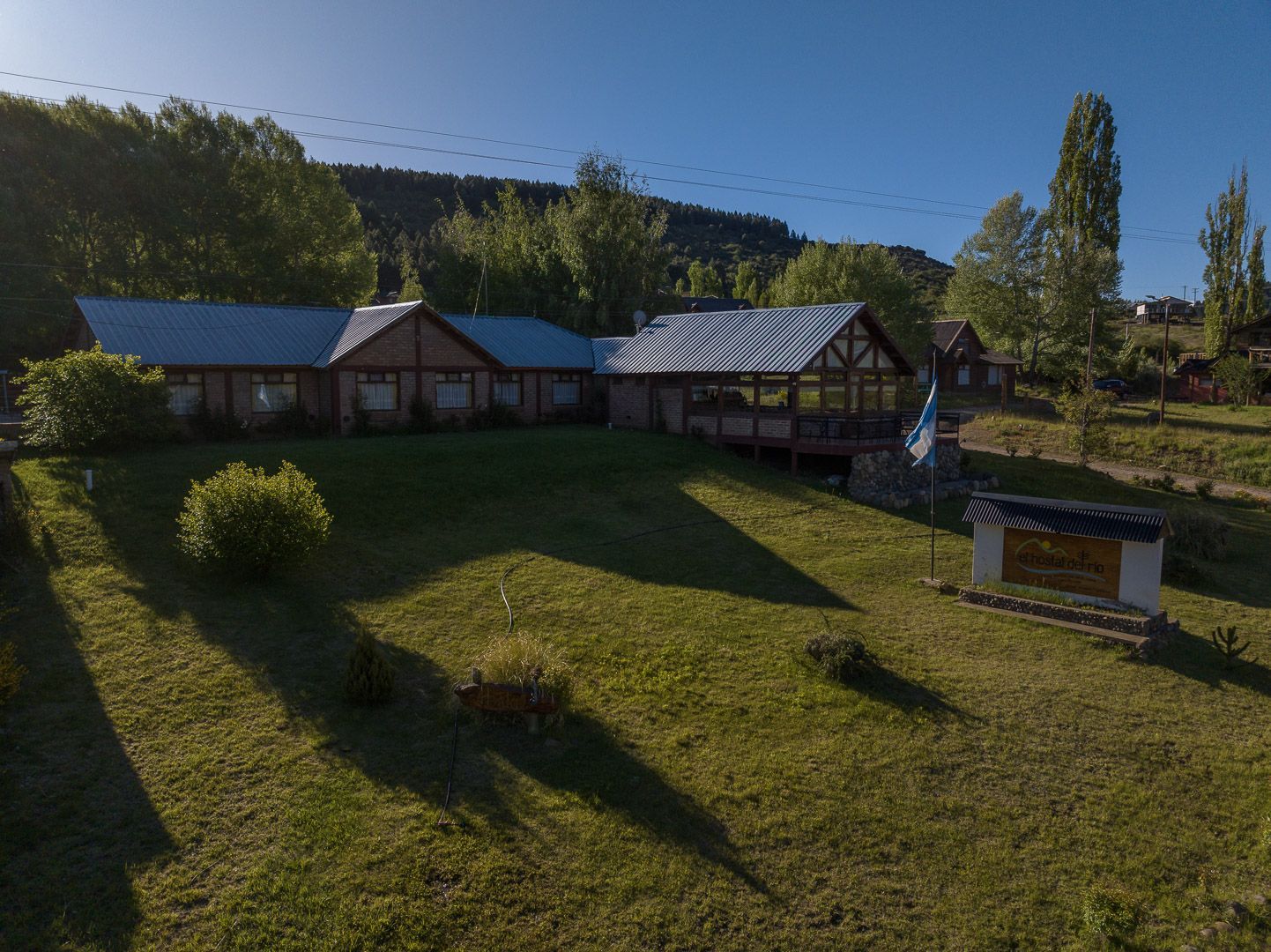 Una vista aérea de una casa en medio de un exuberante campo verde.