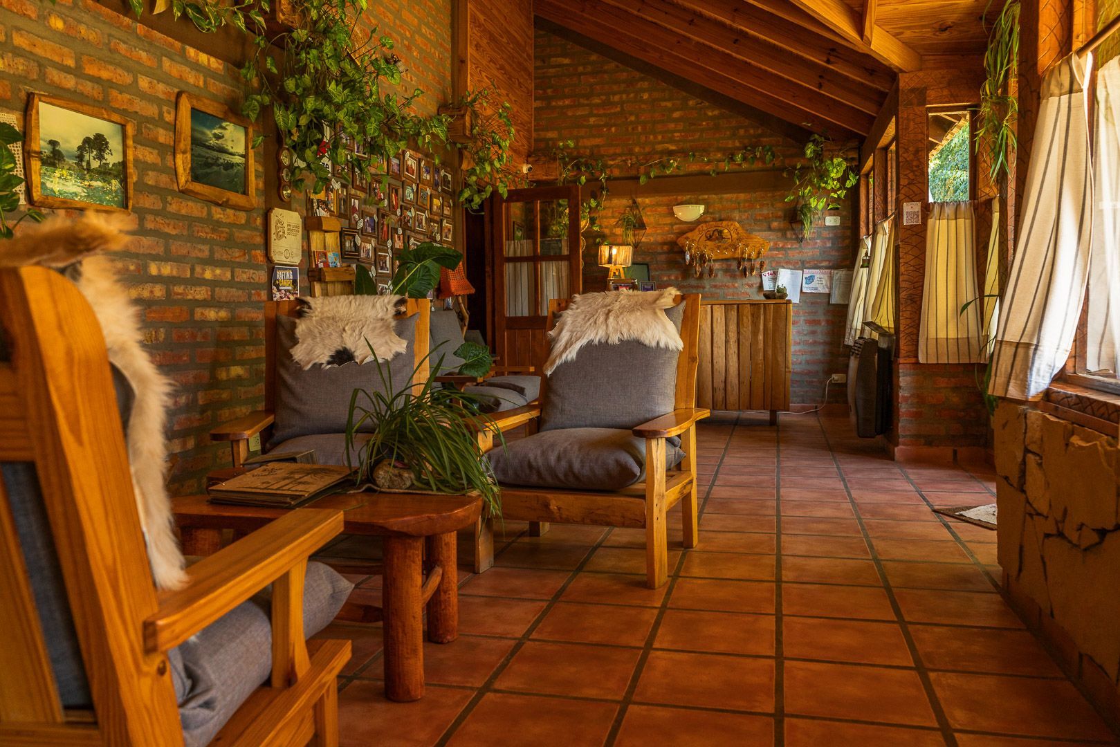 Un salón con muebles de madera y una pared de ladrillo.