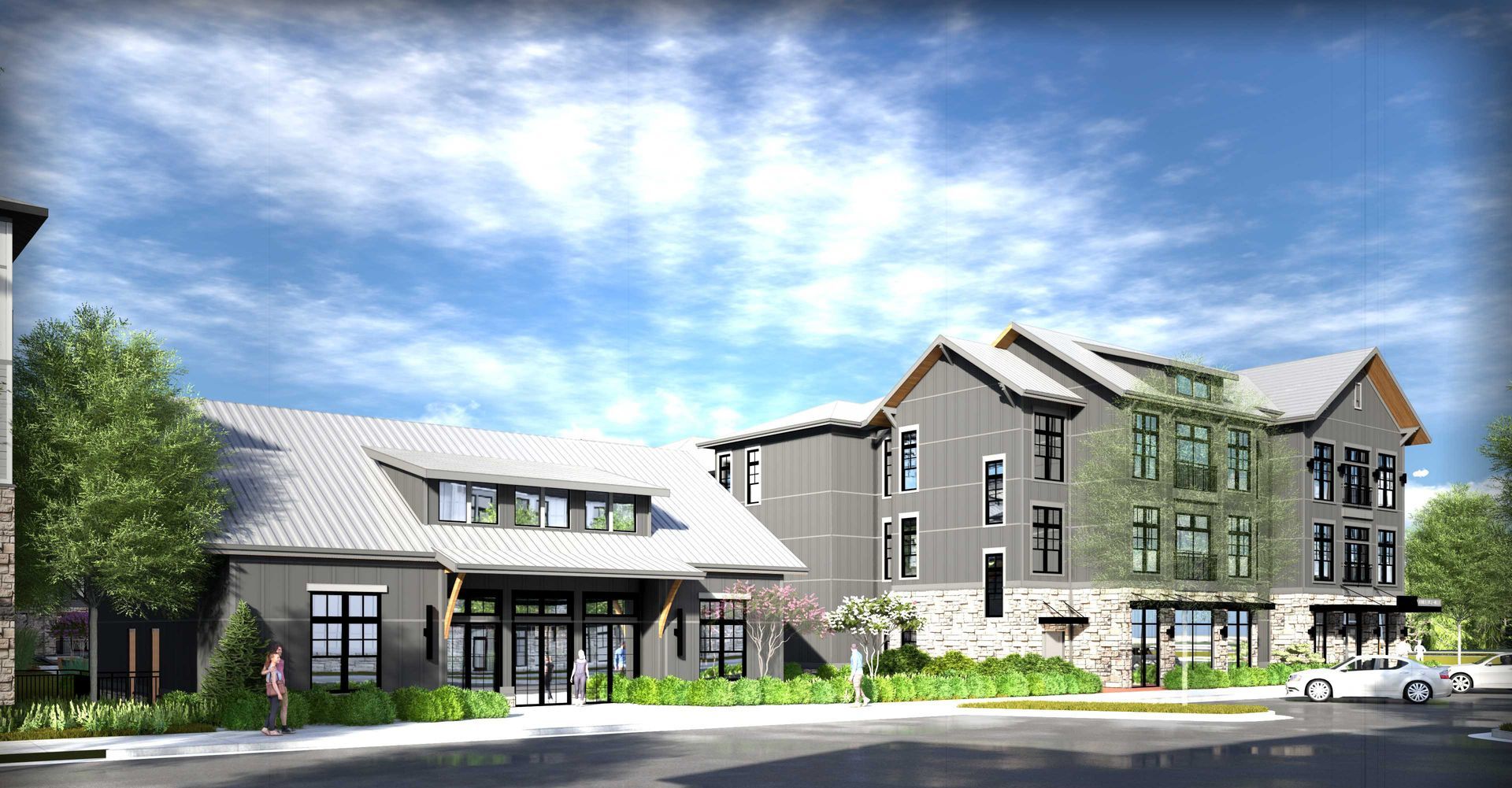 Modern apartment complex with gray siding, stone accents, and a blue sky.