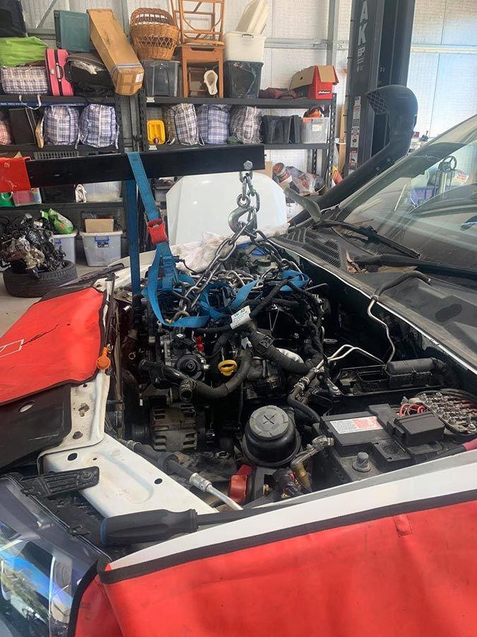 The Engine Of A Car Is Being Removed In A Garage — Dieselflash Whitsundays in Proserpine, QLD
