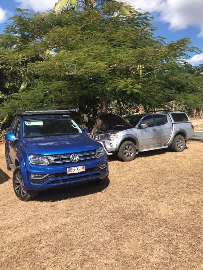 Two Trucks Are Parked Next To Each Other In A Dirt Field — Dieselflash Whitsundays in Proserpine, QLD