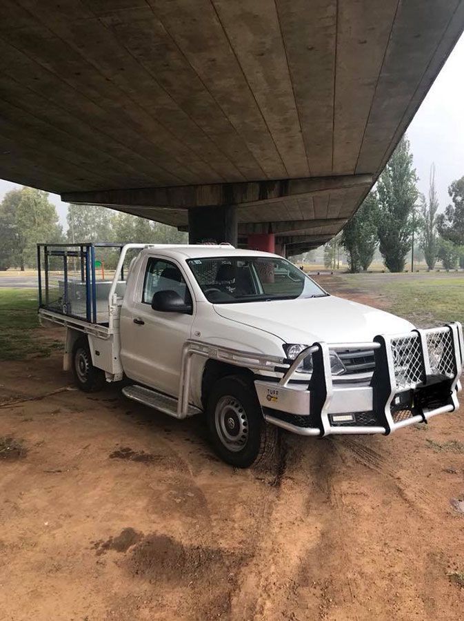 A White Truck Is Parked Under A Bridge — Dieselflash Whitsundays in Bowen, QLD