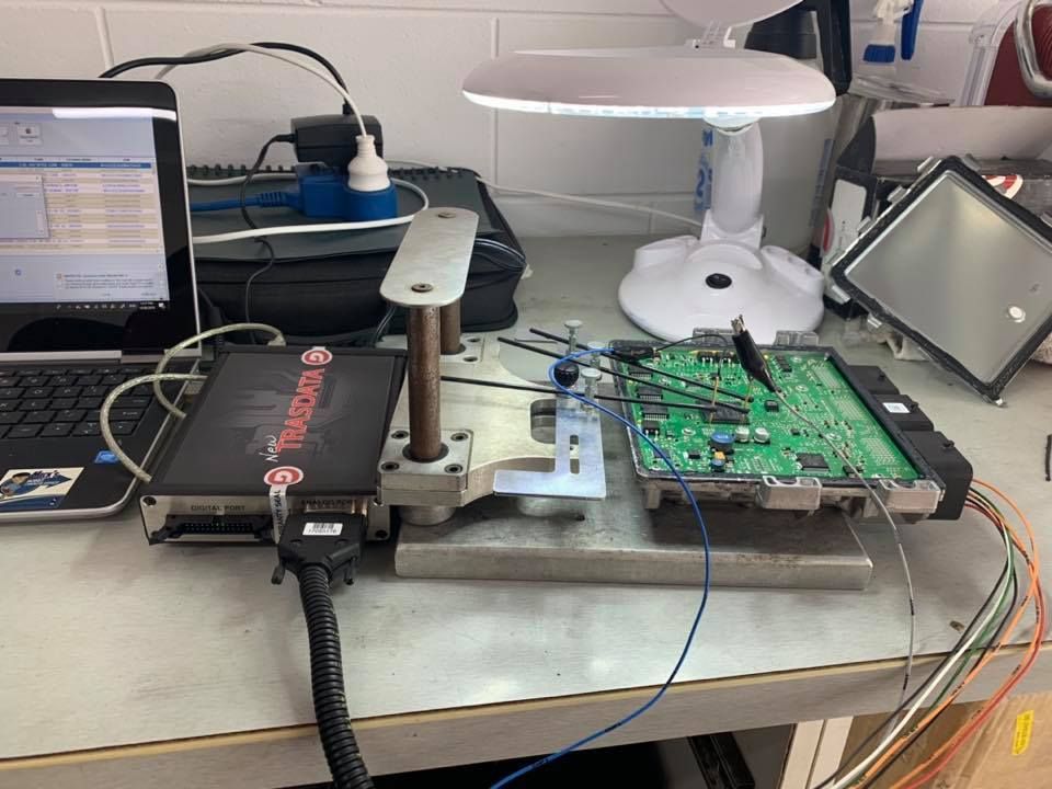 A Desk With A Laptop And A Vehicle ECU — Dieselflash Whitsundays in Airlie Beach, QLD