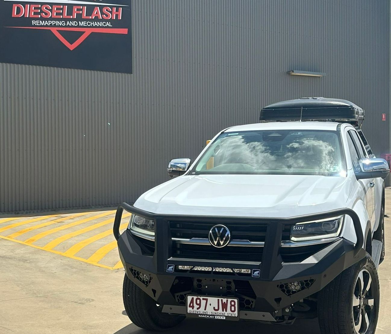 A White Truck is Parked in a Parking Lot in Front of a Building — Dieselflash Whitsundays in Proserpine, QLD