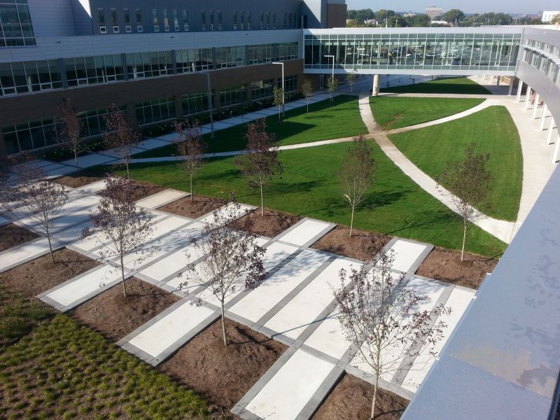 An aerial view of a large building with a lush green lawn