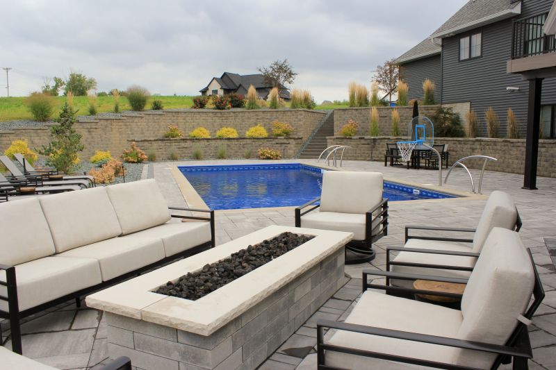 There is a fire pit in the middle of the patio.