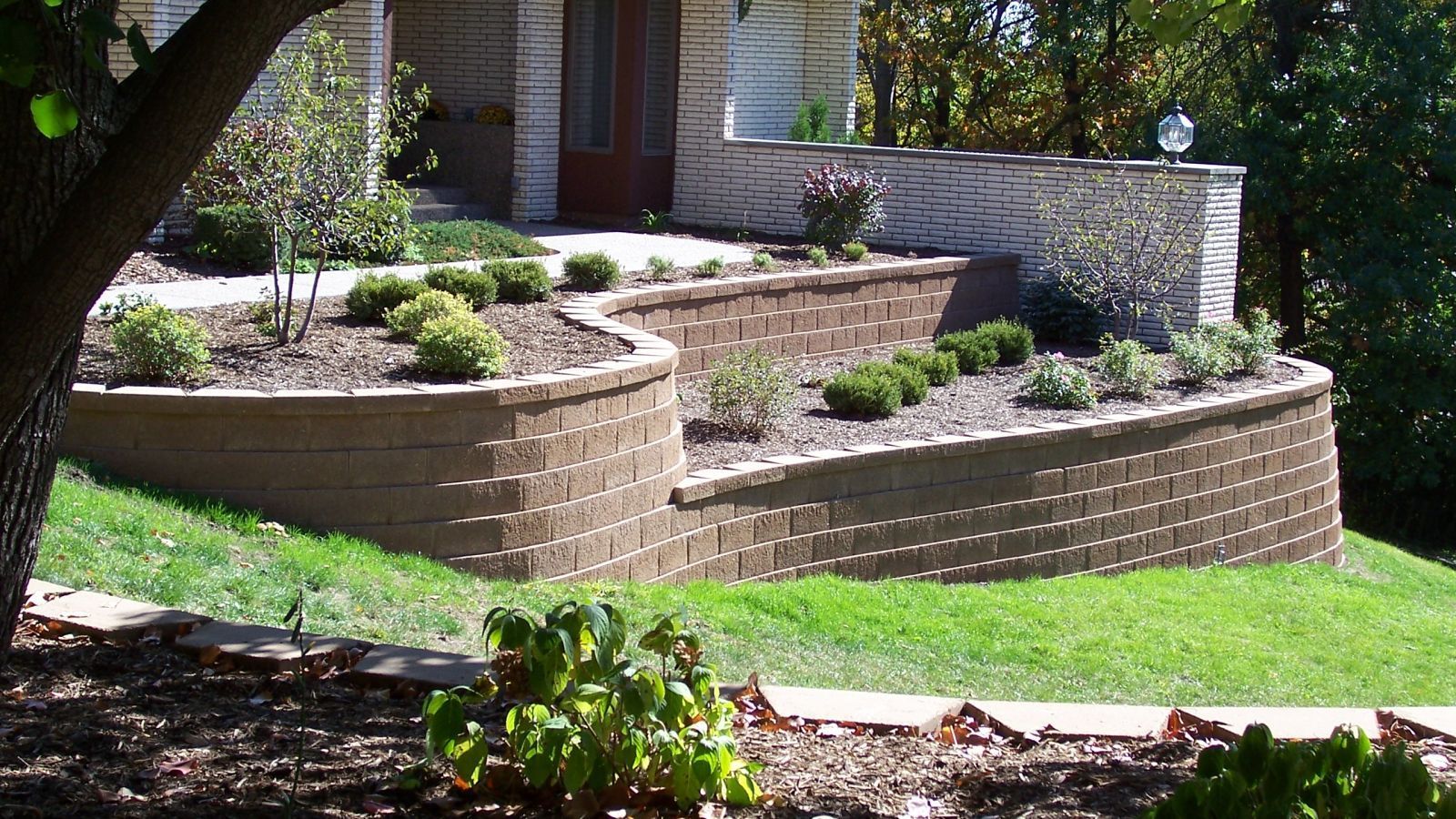 A house with a brick wall in front of it