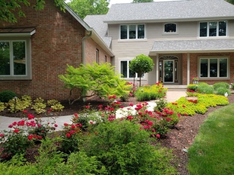 A large brick house with a walkway leading to it