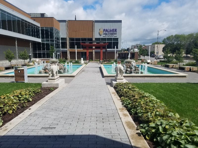 A large building with a fountain in front of it