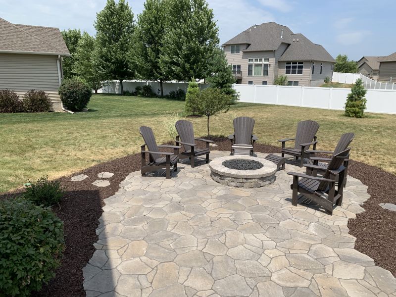 An aerial view of a patio with a house in the background