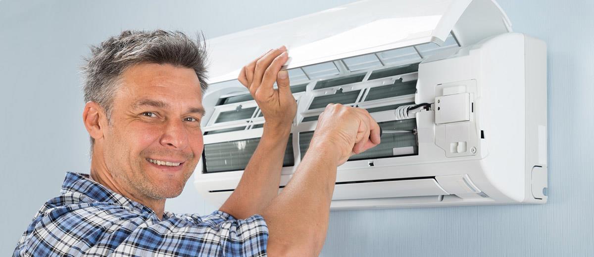 Male Technician Repairing Air Conditioner — Sewickley, PA — Sta So Cool HVAC