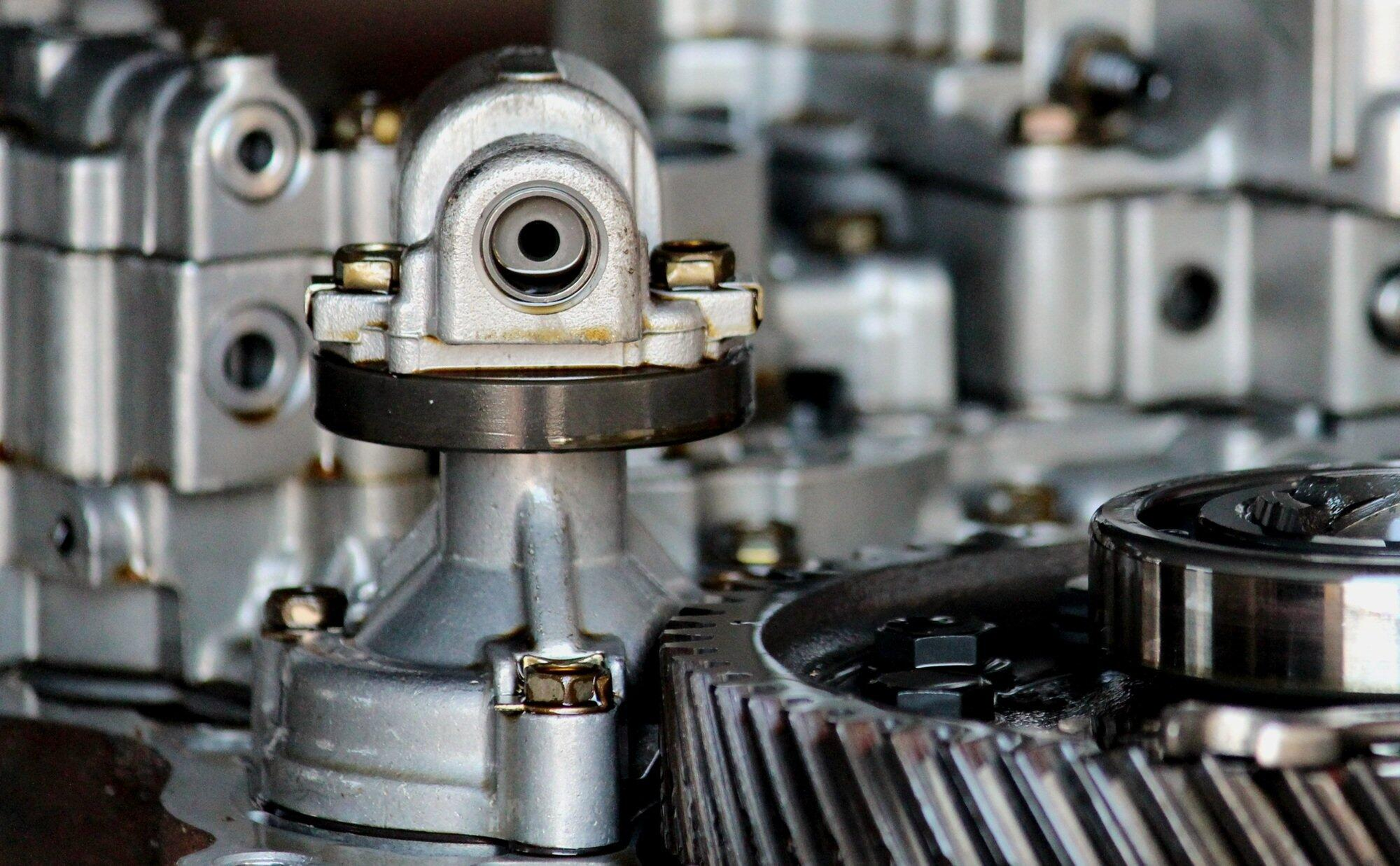 Close-up of industrial metal gears and mechanical components in a factory setting