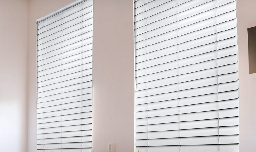 two faux wood white blinds are hanging on a window in a room All Window Decor (817) 448-3393.