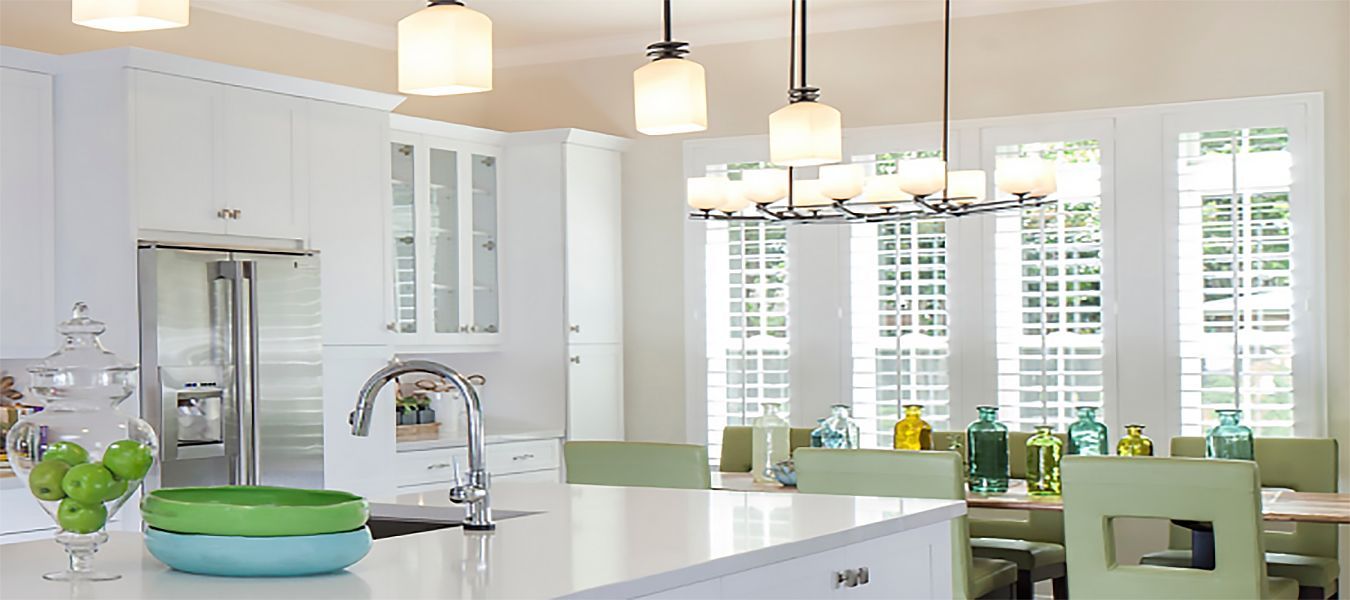 a kitchen with white cabinets and a green bowl on the counter All Window Decor (817) 448-3393