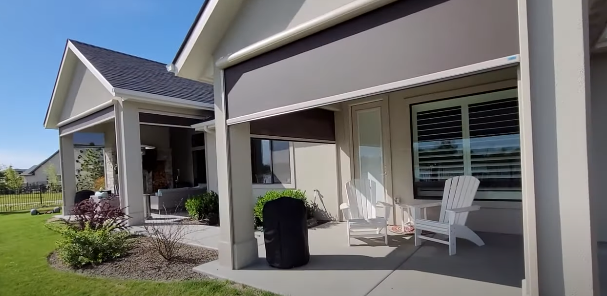 a house with a porch and chairs on it with exterior shades All Window Decor (817) 448-3393.