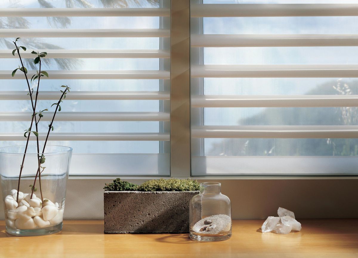 a window with shades and a plant in a vase All Window Decor (817) 448-3393