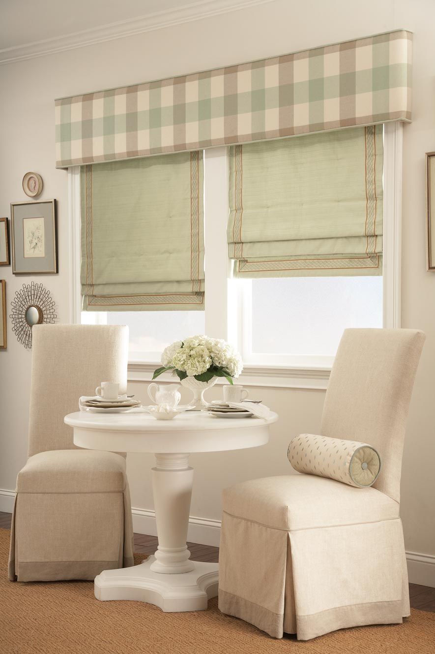 a dining room with a table and chairs and roman shades on the windows All Window Decor (817) 448-3393.