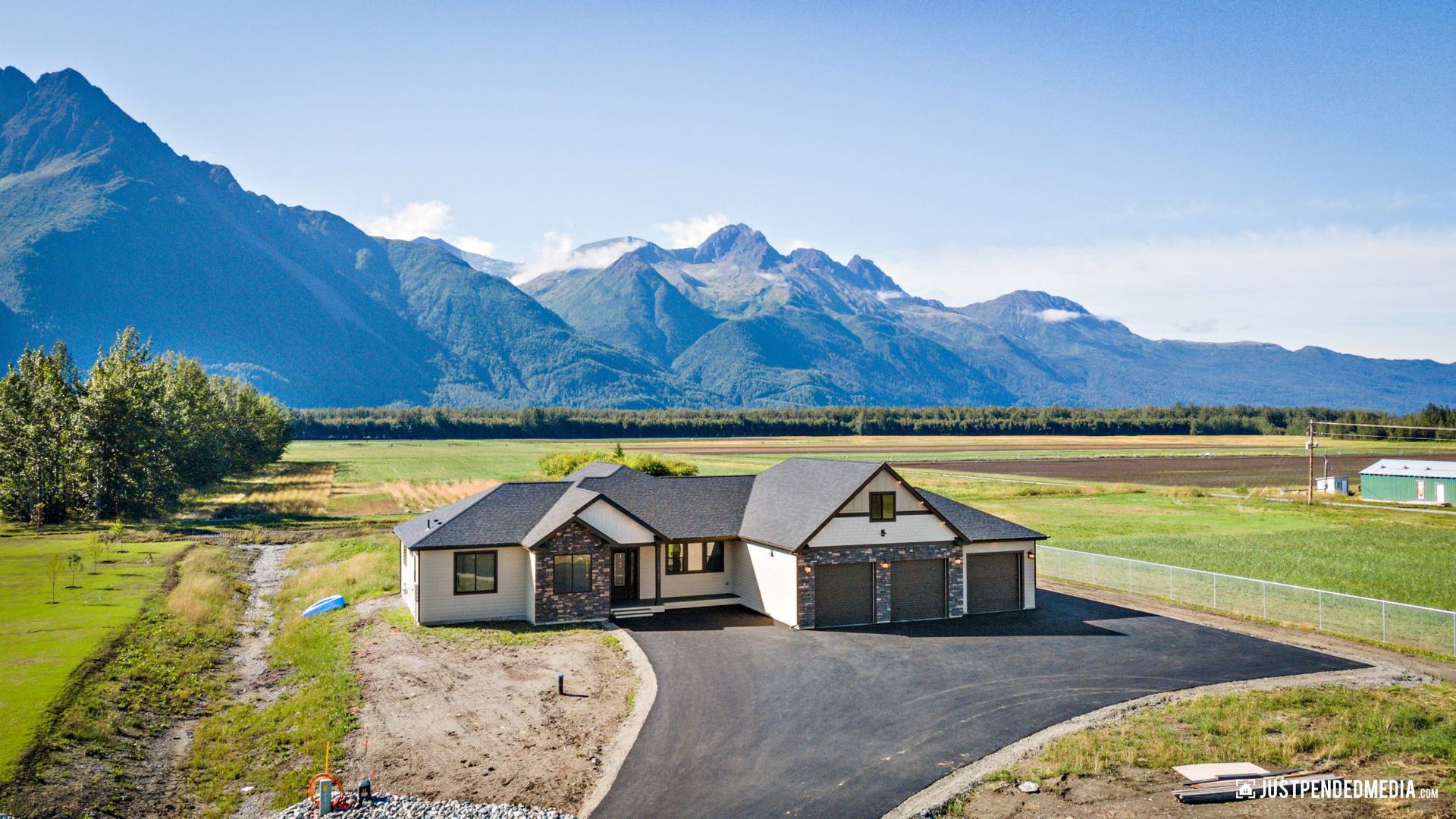 brown house with mountains in background