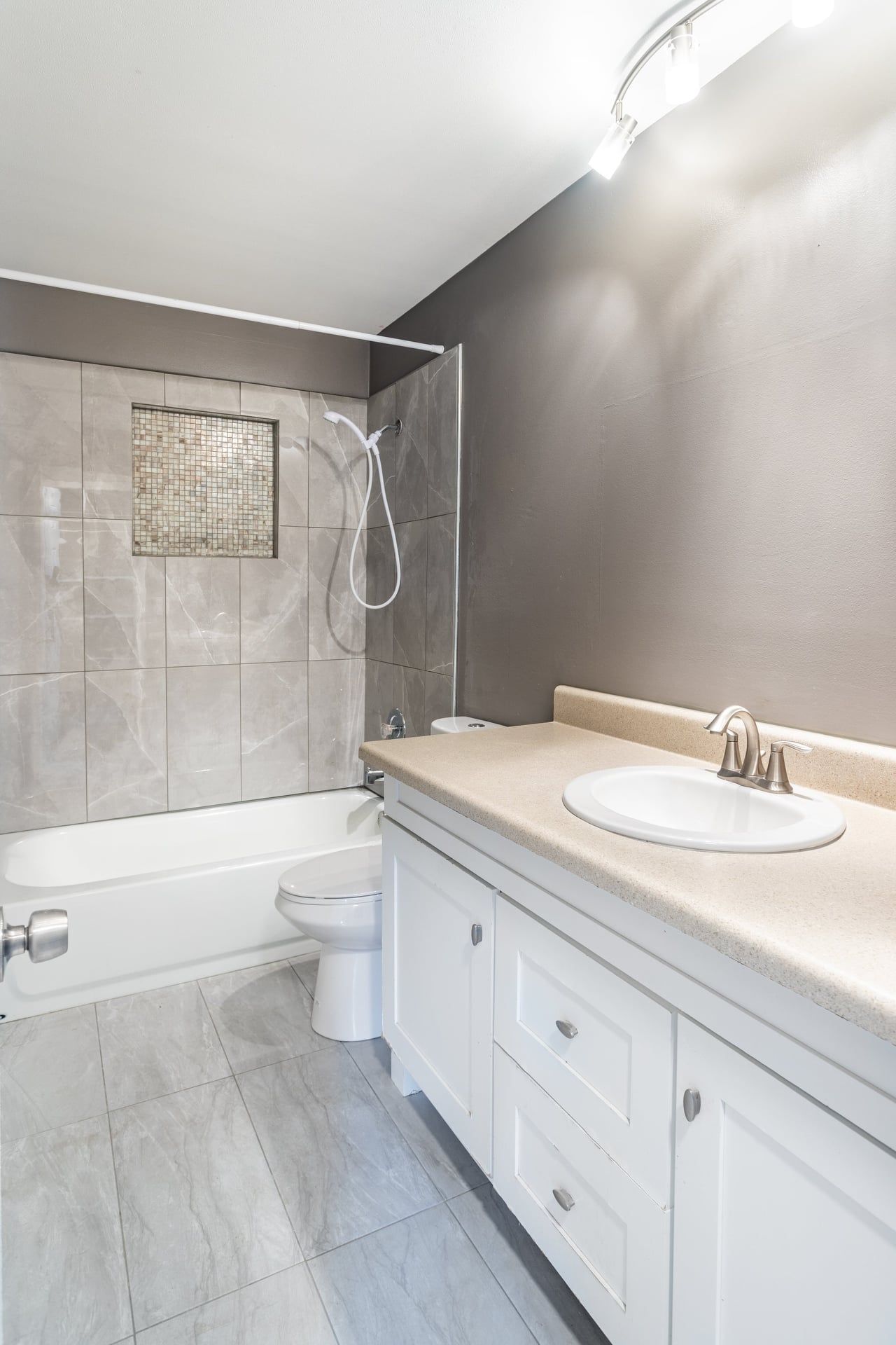 a bathroom with a sink , toilet , tub and shower .