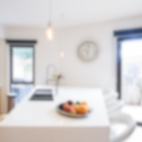 a blurry picture of a kitchen with a clock on the wall