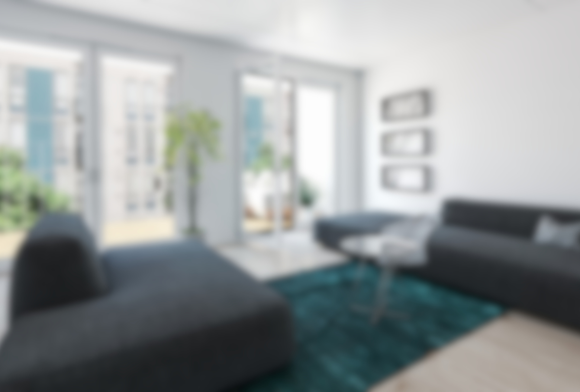 a blurry picture of a living room with a couch , chair and table .