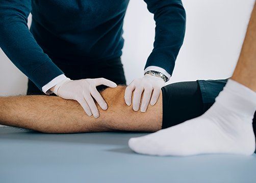 Therapist Adjusting Patient Knee — Wichita, KS — Advanced Chiropractic