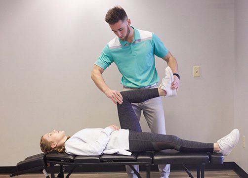 Massaging Left Knee — Wichita, KS — Advanced Chiropractic