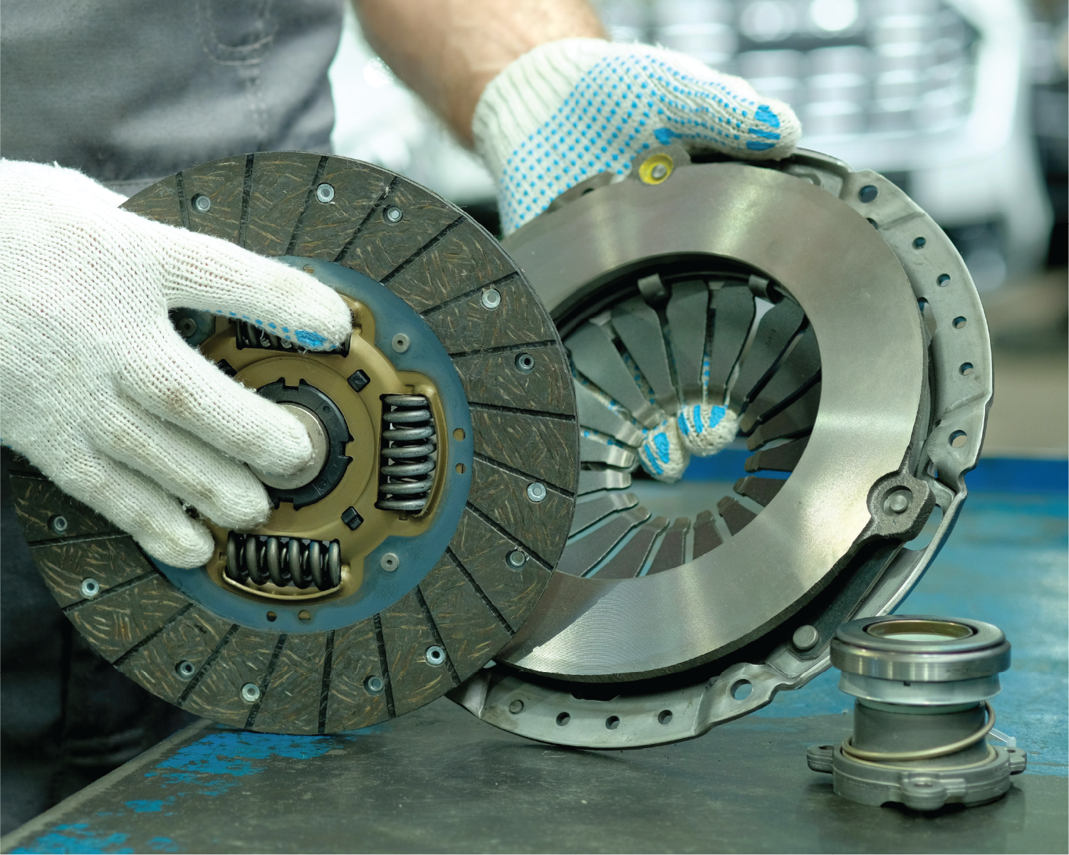 A person is holding a clutch disc in their hands.