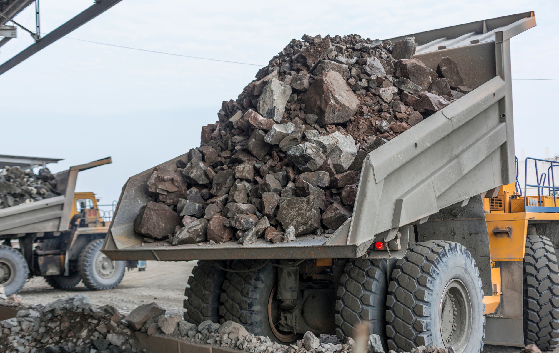 A dump truck is loaded with rocks in a quarry.