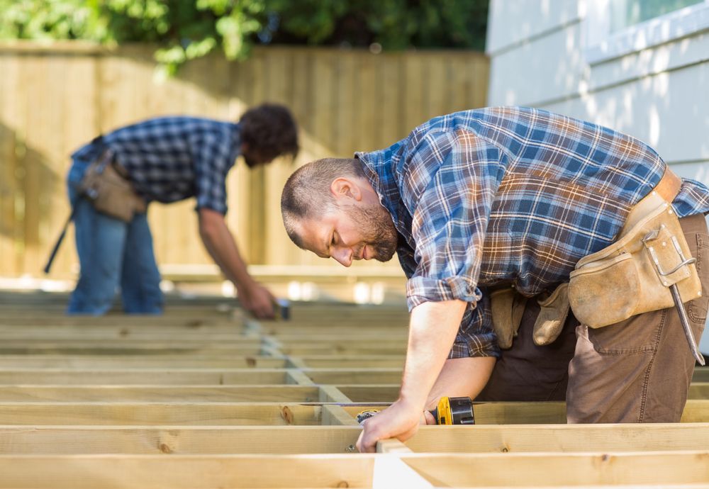 Two Construction Workers Building a Wooden Deck Outdoors — Lunny's Carpentry In Dubbo, NSW