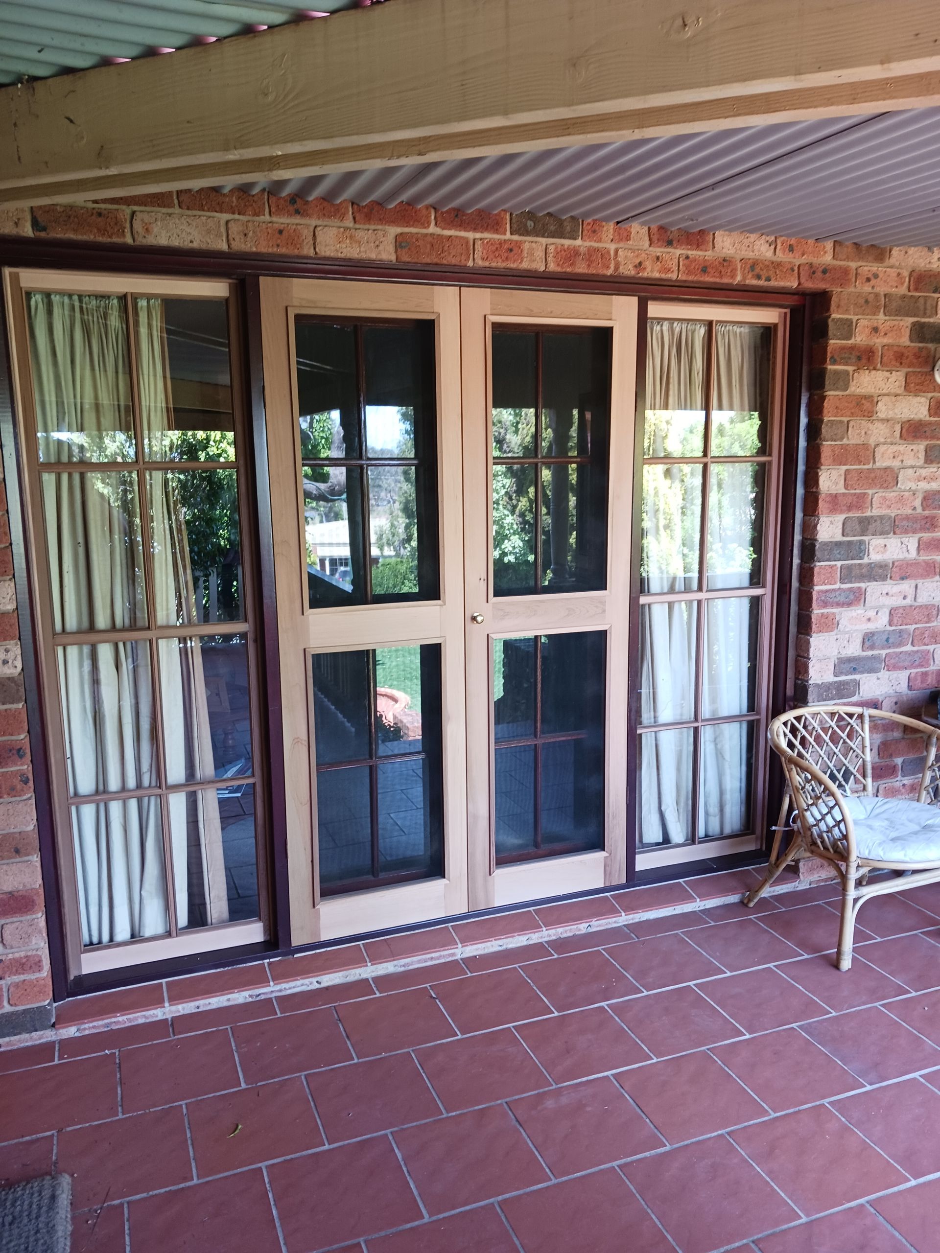 Wooden Framed Doors with Glass Panes and Screens on a Brick Patio — Lunny's Carpentry In Dubbo, NSW