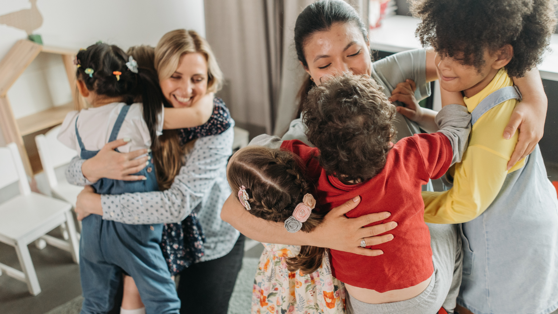 A group of people are hugging each other in a room.