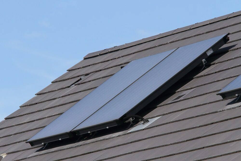 A Roof With Two Solar Panels On It — IPOWER Industries In Airlie Beach, QLD