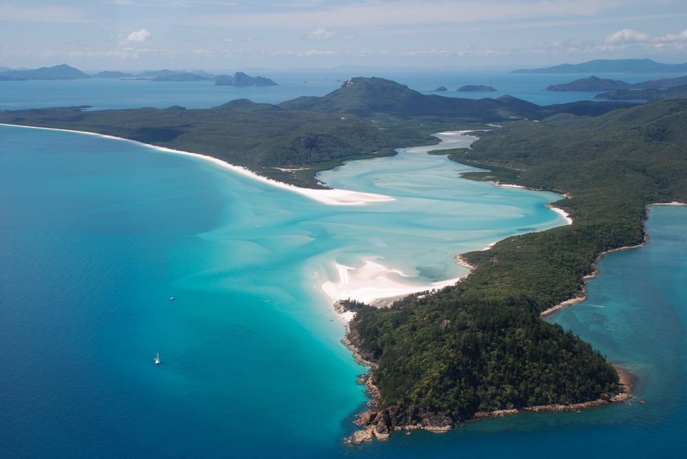 A Small Island In The Middle Of A Large Body Of Water Surrounded By Mountains — IPOWER Industries In Airlie Beach, QLD