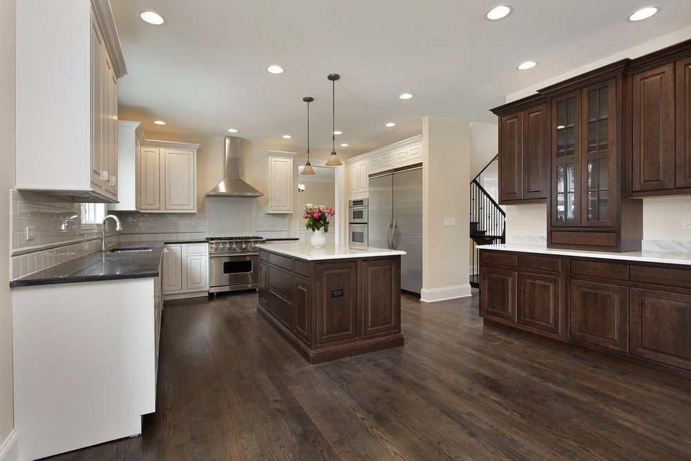 A Kitchen In A New Home With Hardwood Floors And Stainless Steel Appliances — IPOWER Industries In Cannonvale, QLD