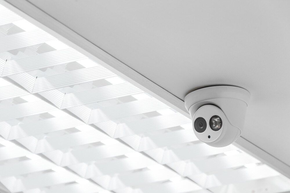 A Security Camera Is Mounted On The Ceiling Of A Building — IPOWER Industries In Airlie Beach, QLD