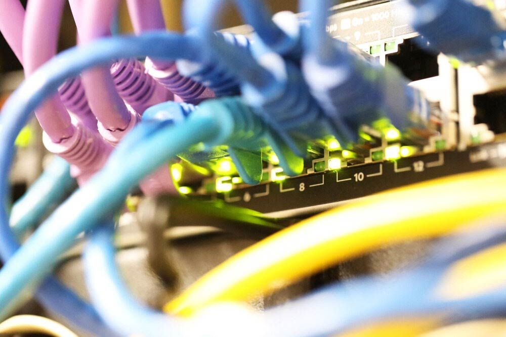 A Bunch Of Ethernet Cables Are Connected To A Router — IPOWER Industries In Airlie Beach, QLD