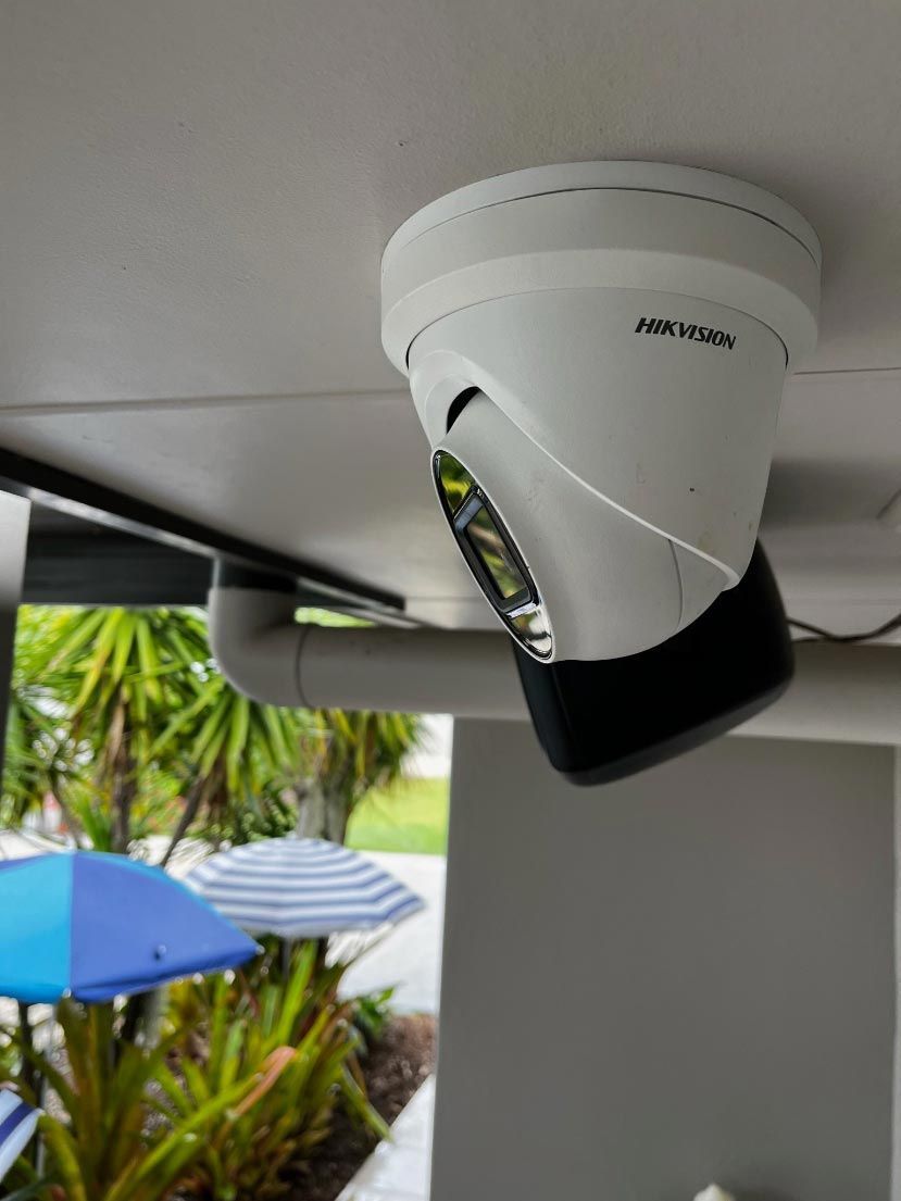 A Hikvision Camera Is Mounted To The Ceiling Of A Building — IPOWER Industries In Cannonvale, QLD