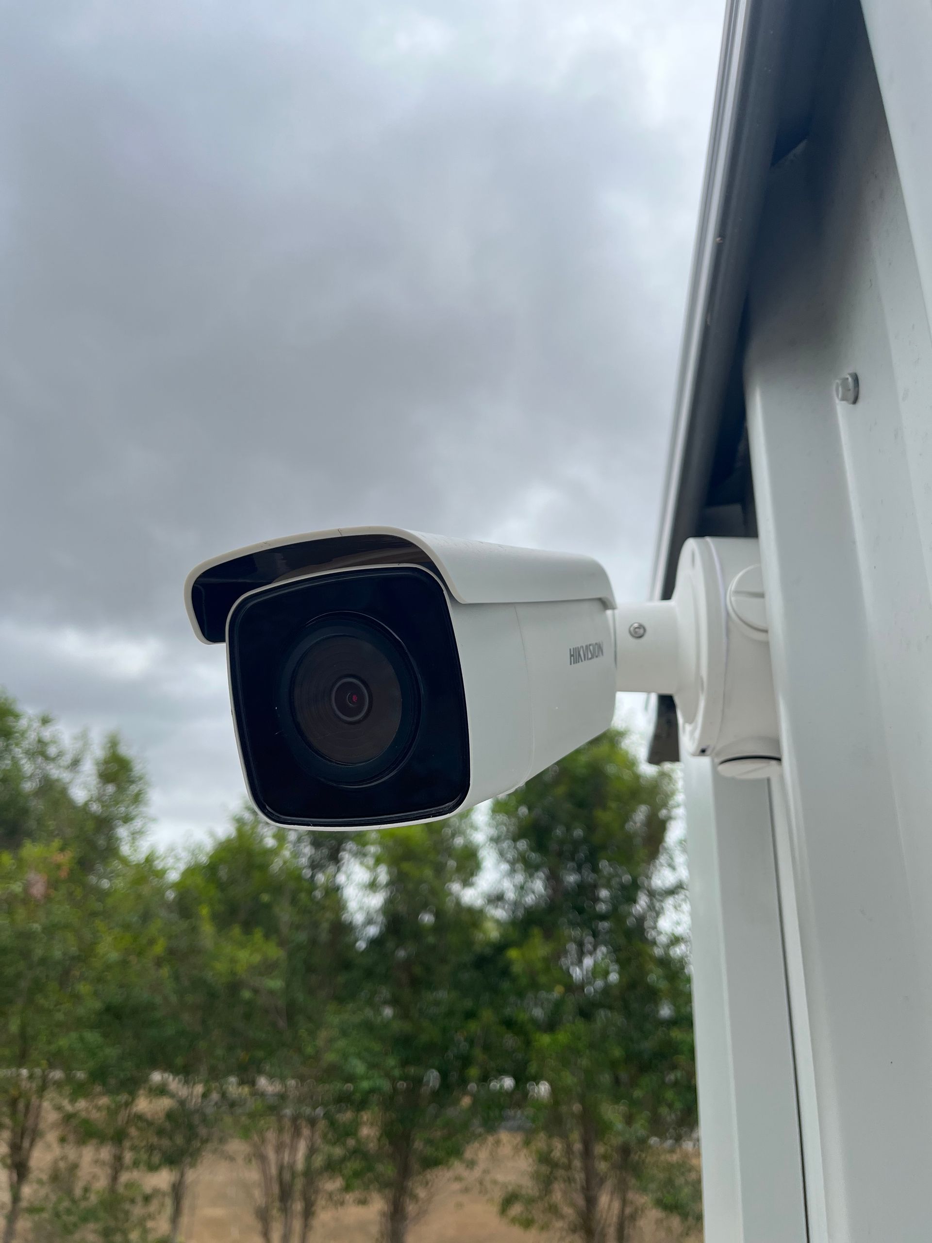 A Security Camera Is Mounted On The Side Of A Building — IPOWER Industries In Proserpine, QLD