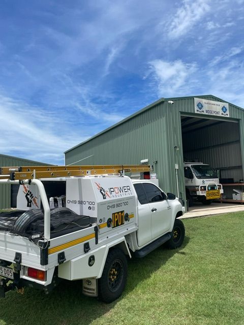 A White Truck Is Parked In Front Of A Building — IPOWER Industries In Bowen, QLD