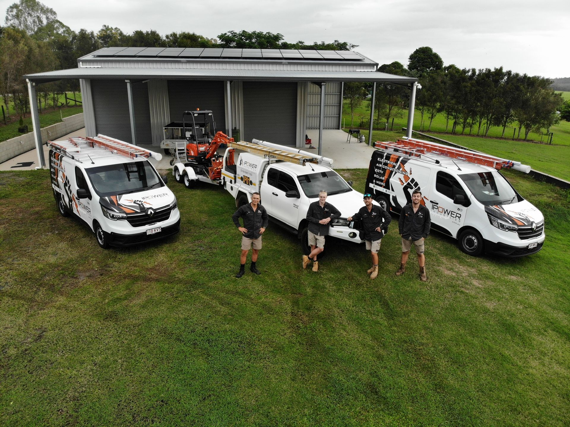 A White Truck and White Van are Parked Outside A Warehouse — IPOWER Industries In Strathdickie, QLD