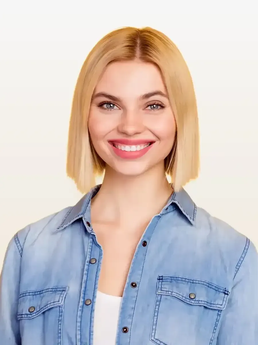 The woman is wearing a denim shirt and smiling.