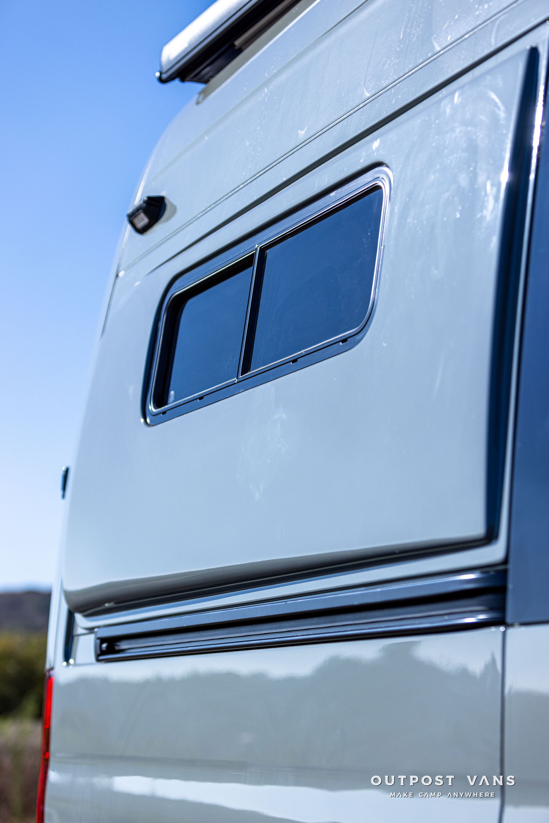 A white van with a window on the side of it.