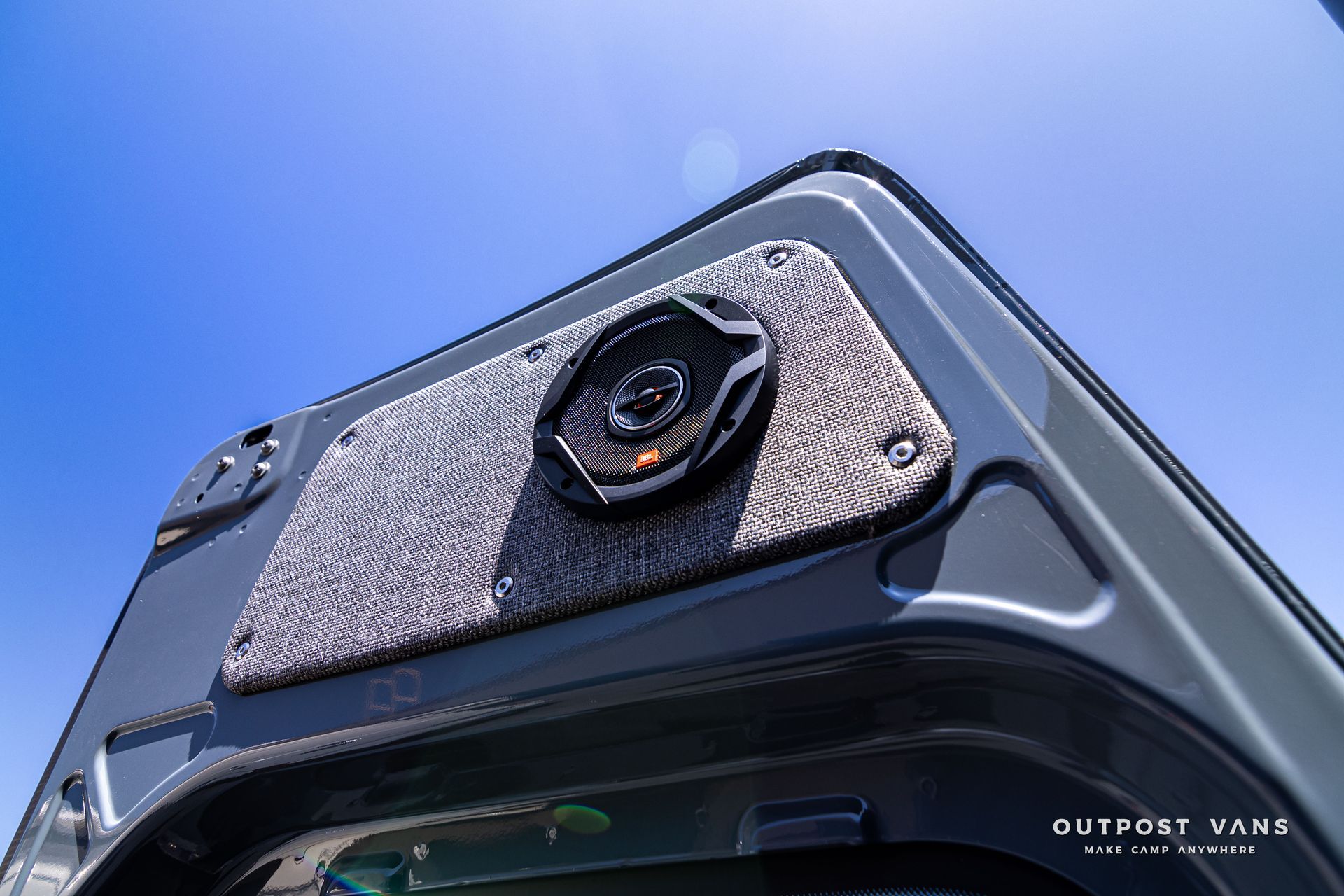 A close up of a speaker on the back of a VAN