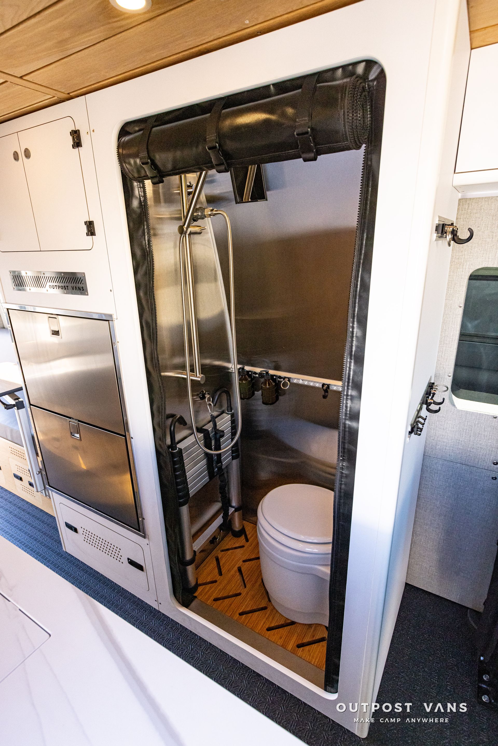A bathroom with a toilet and stainless steel cabinets