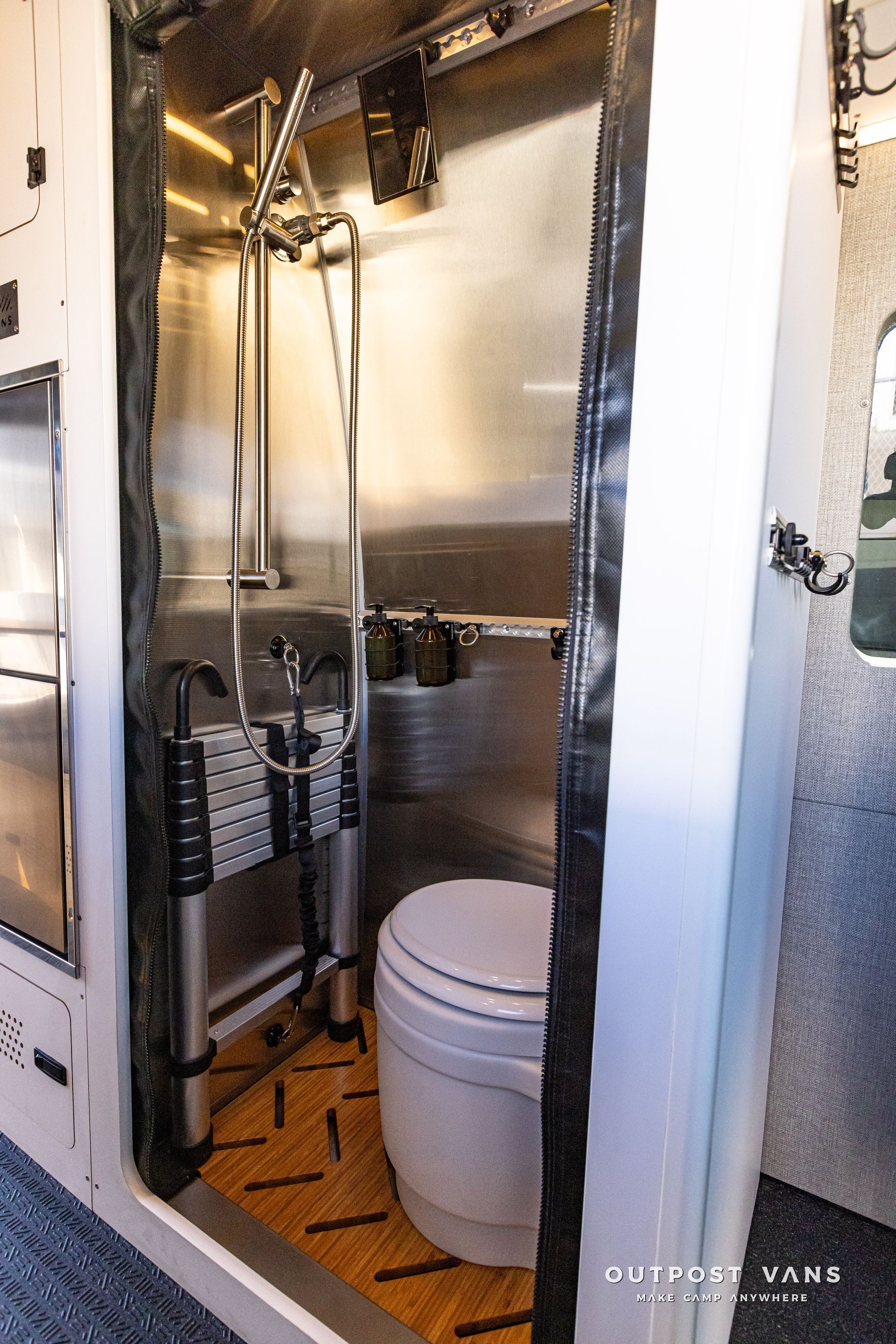A bathroom with a toilet , sink and shower.