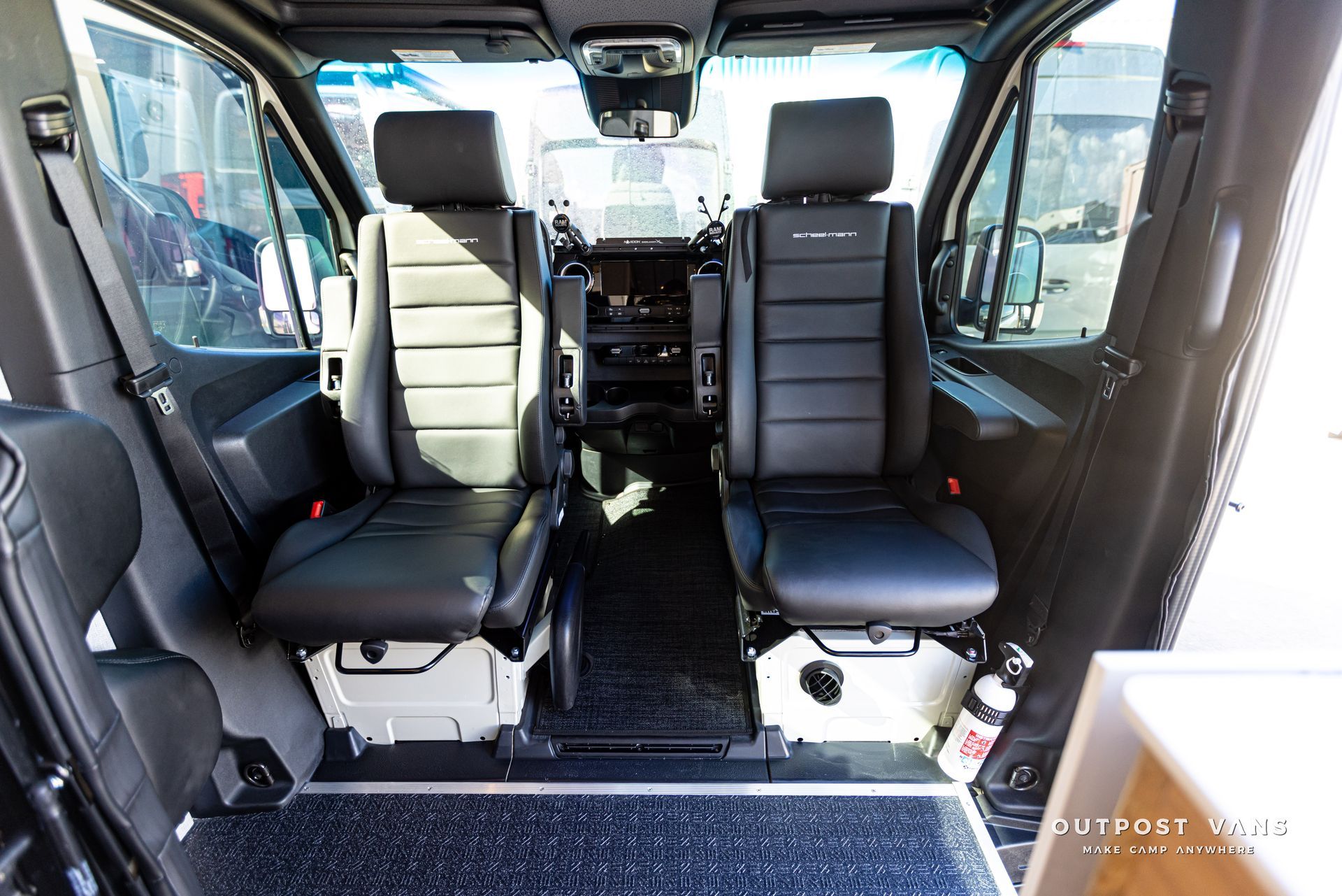 The inside of a van with black leather seats