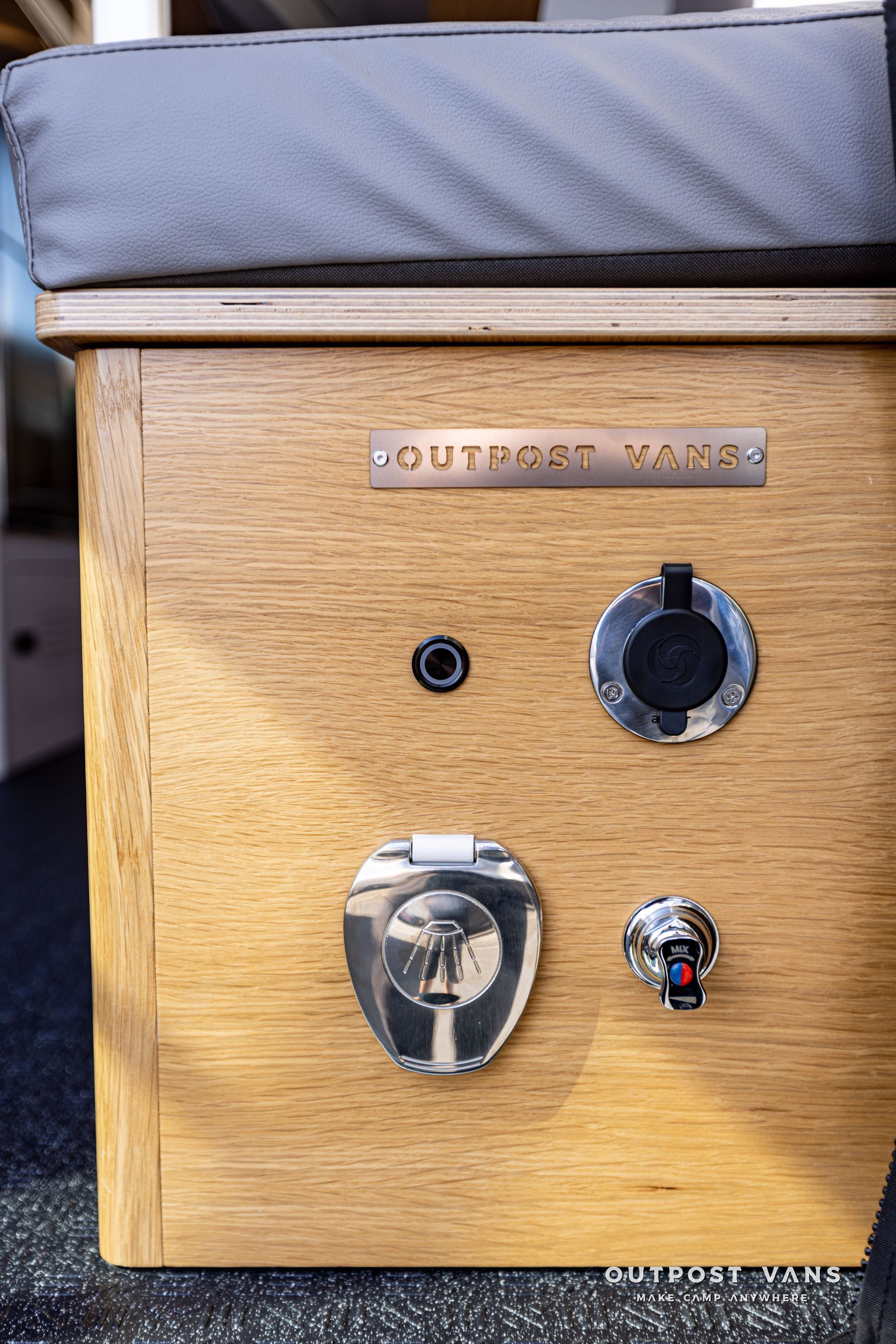 A wooden box with a cushion on top of it.