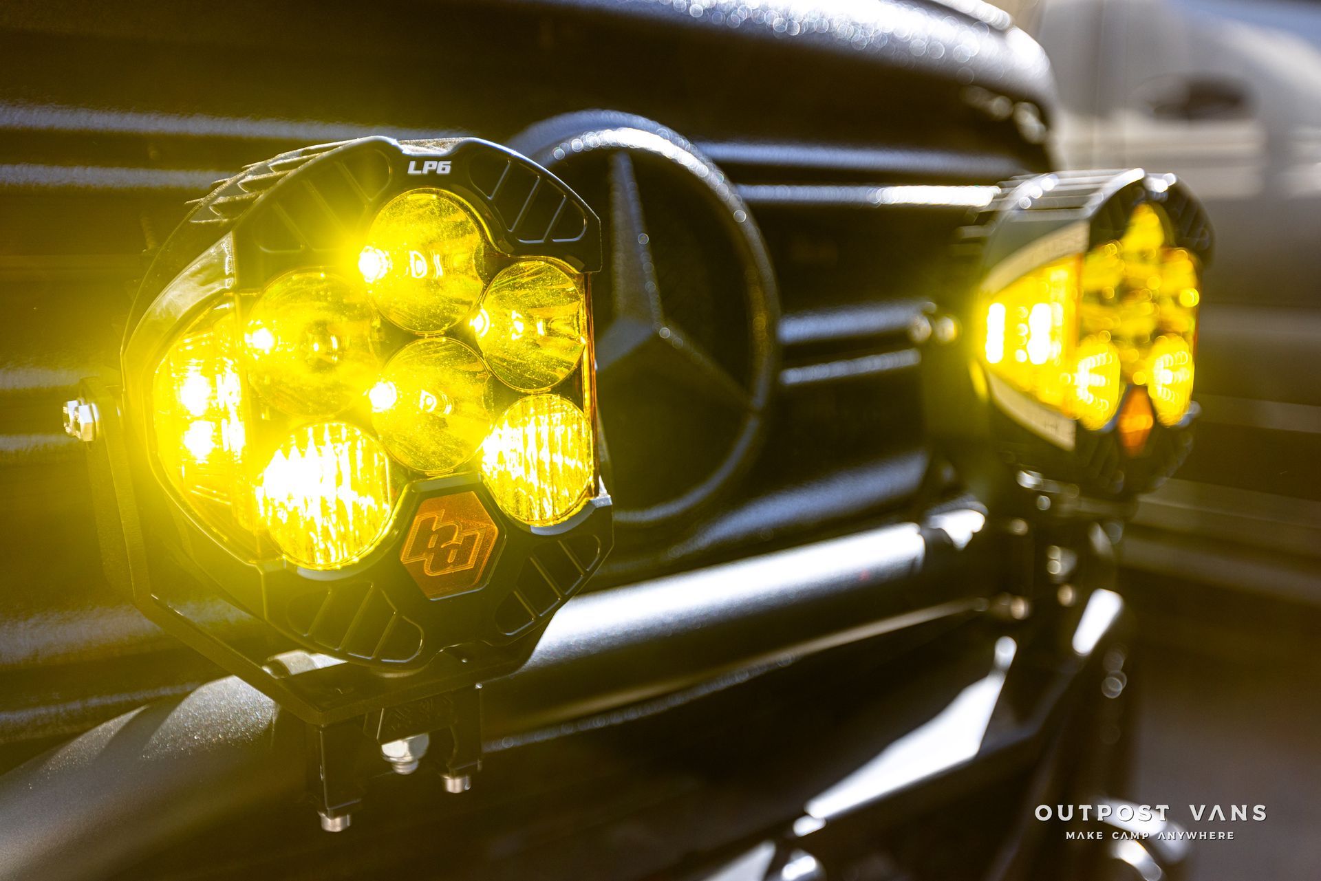 A close up of a black car with yellow lights on it.